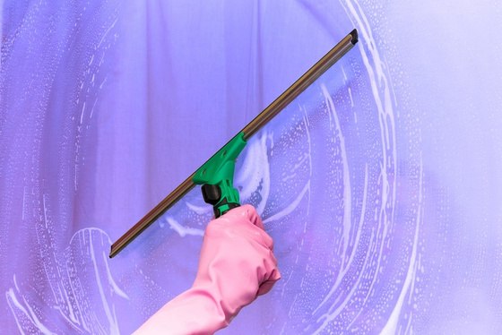 Squeegee cleaning a glass surface